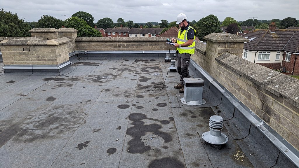 Building surveyor inspecting a flat roof on a residential property in Hampshire