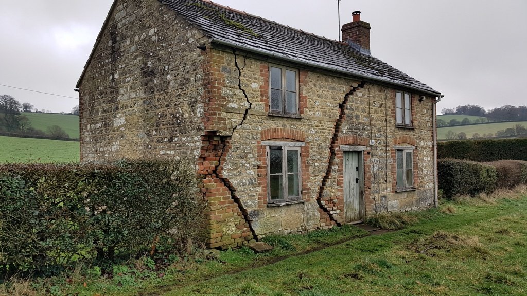 Period Hampshire cottage showing diagonal cracks indicating subsidence and structural movement